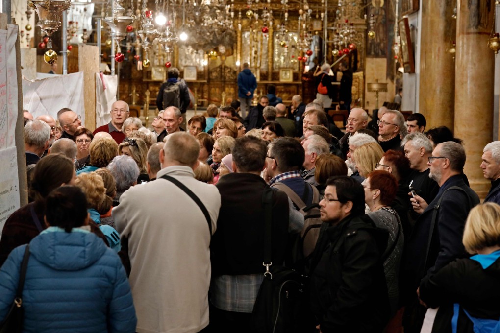 A group of tourists and pilgrims visit the Church of the Nativity. Photo: AFP