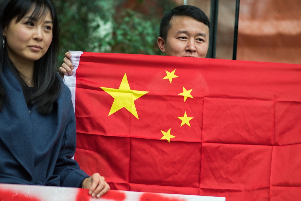 A man holds a Chinese flag in support of Huawei executive Meng Wanzhou outside a bail hearing in Vancouver on December 11. China has reacted to the incident by hitting back at Canada, instead of winning more friends around the world. Photo: Bloomberg