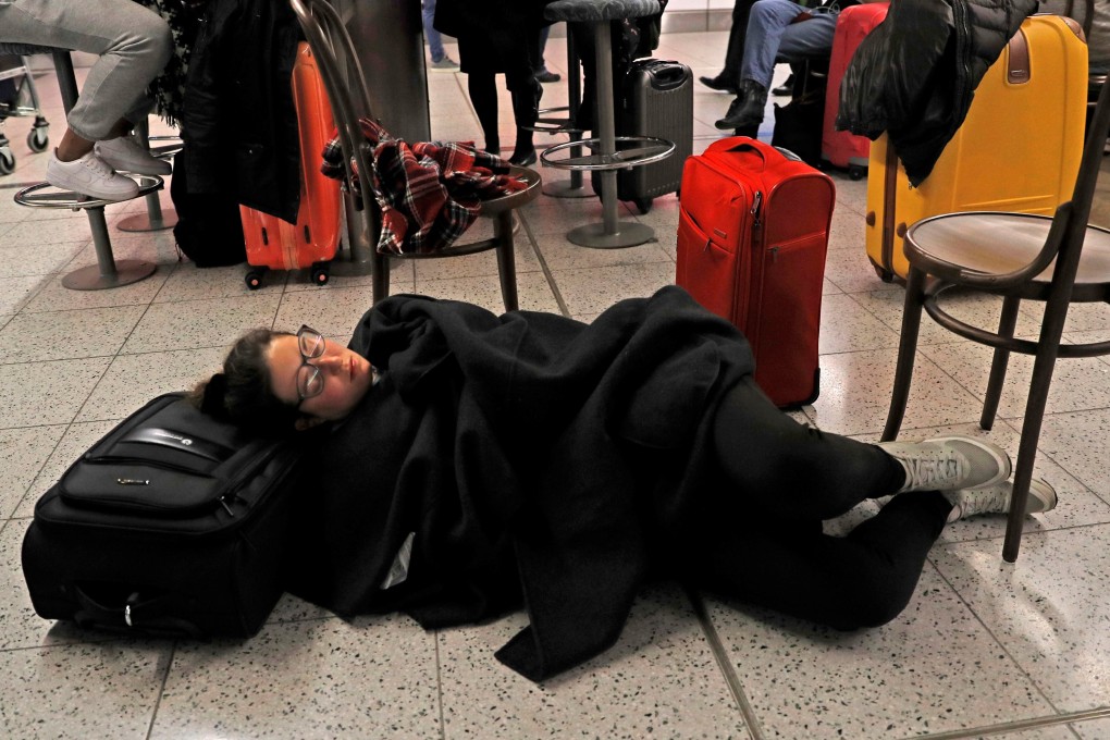 Passengers wait in the South Terminal building at Gatwick Airport after drones flying illegally over the airfield forced the closure of the airport. Photo: Reuters