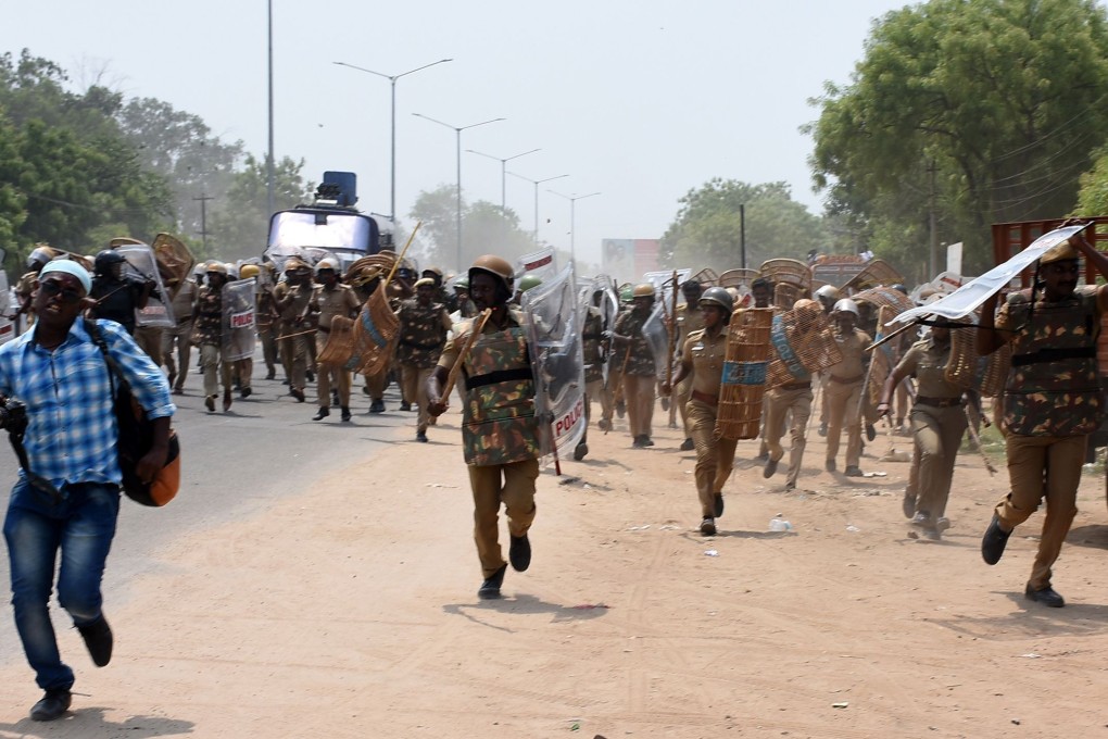 Police charge towards protesters during the protests. Photo: AFP