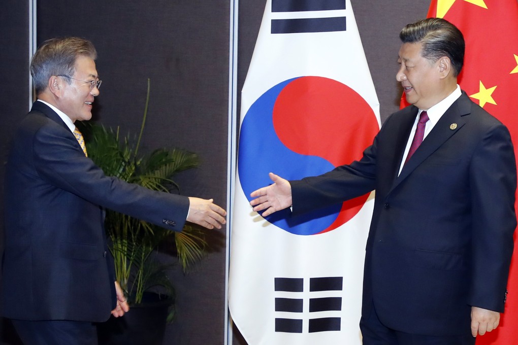 South Korean President Moon Jae-in (left) and Chinese President Xi Jinping greet each other at the Apec summit in Port Moresby, Papua New Guinea, on November 17. Photo: EPA-EFE/Yonhap