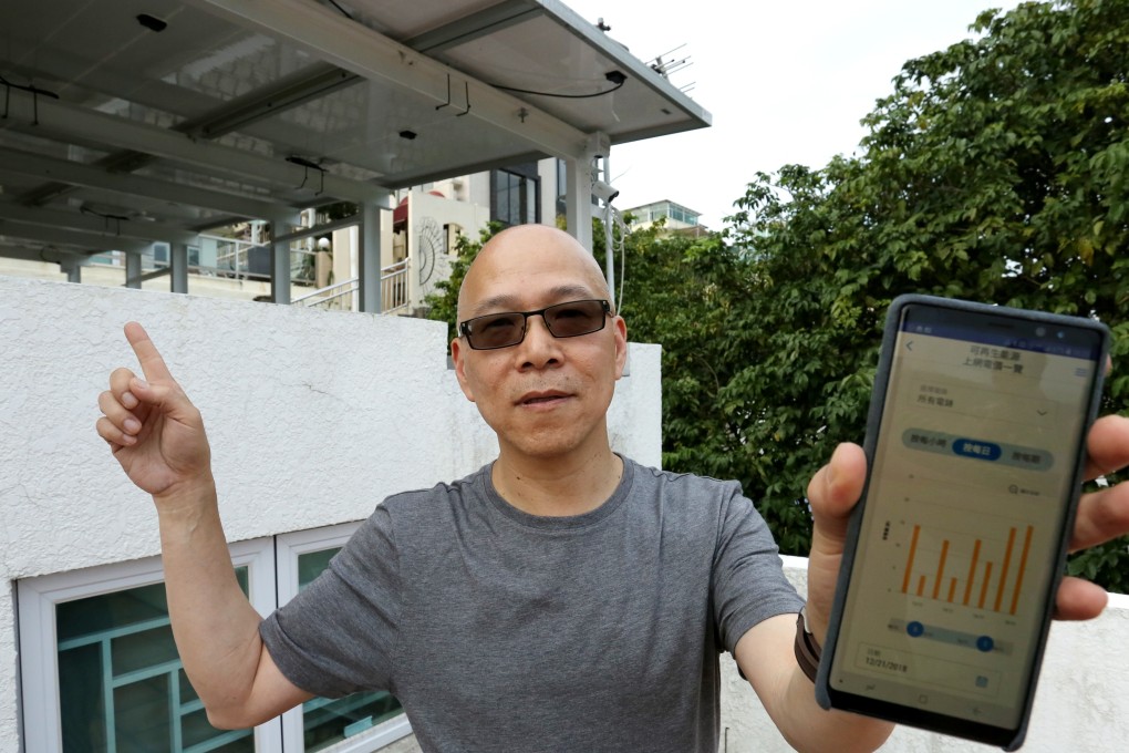 Sai Kung resident Ko Chi-kwong demonstrates the feed-in tariff dashboard on the China Light Power app. Photo: Jonathan Wong