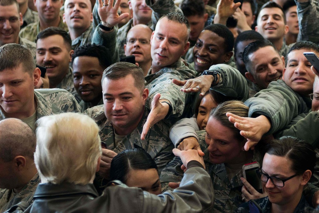 US troops reach out to President Donald Trump after a speech at an airbase last year. Photo: AFP