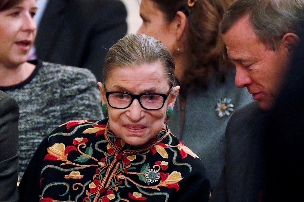 US Supreme Court Justice Ruth Bader Ginsburg talks with Chief Justice John Roberts as they attend a ceremony at the White House on November 16. Photo: Reuters