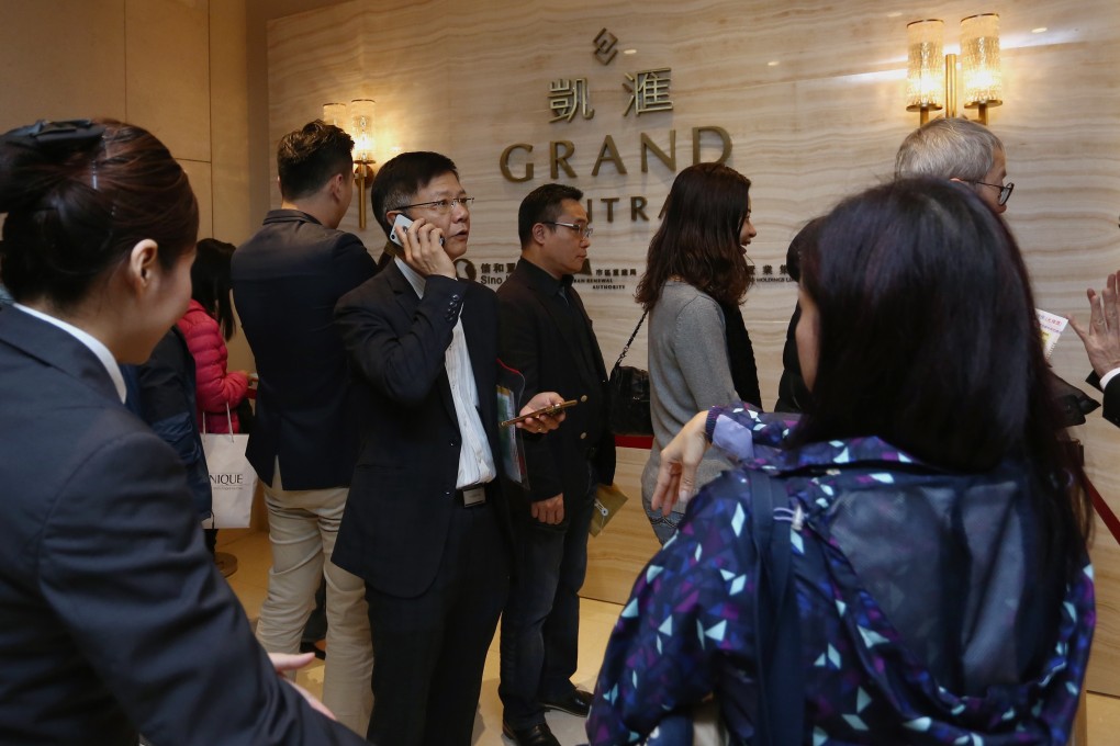 Potential buyers queue up for their chance to buy flats at Sino Land’s sales centre in Tsim Sha Tsui. Photo: Jonathan Wong