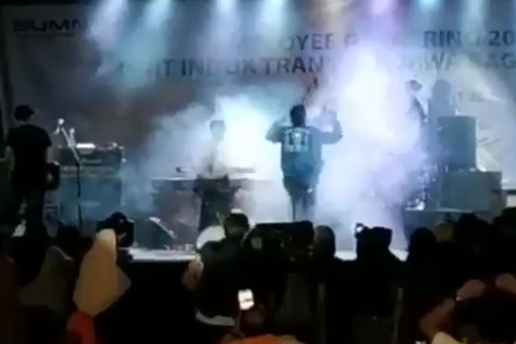 The band Seventeen moments before a large wave crashed into the rear of the beachside stage on which they were performing. Photo: Twitter