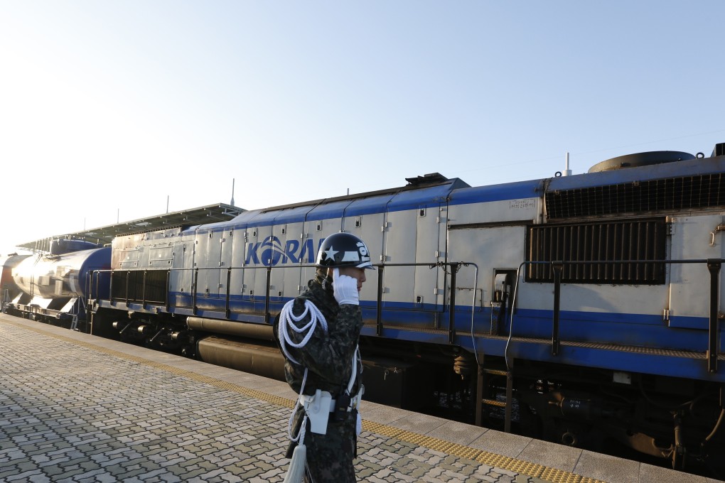 A South Korean army soldier stands next to a train before it crosses the border into North Korea. Photo: AP