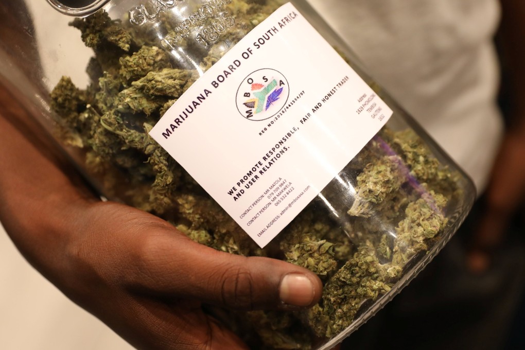 A man holds a jar full of cannabis buds at an expo in Pretoria, South Africa on December 13, 2018. Photo: Reuters