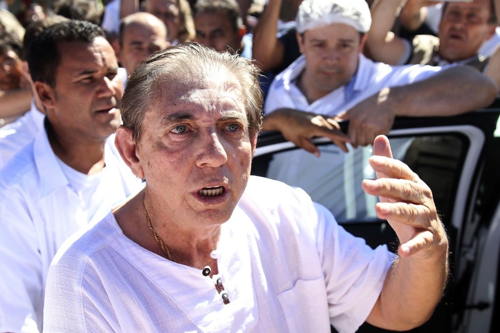 In this handout photo released by Agencia Brasil, spiritual healer Joao Teixeira de Faria, better known as John of God, arrives to the Dom Inacio Loyola House in Abadiania, Brazil. Photo: Agencia Brasil via AP