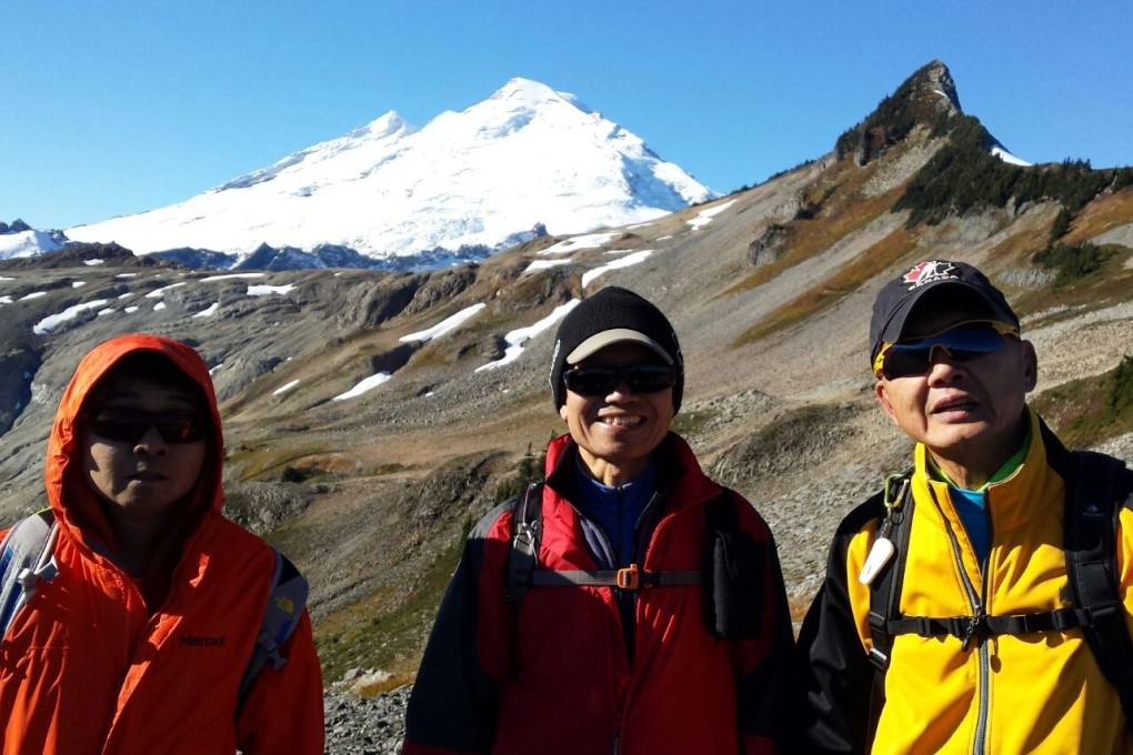 Roy Lee Tin-hou (left, orange jacket) and Lam Chun-sek (right, yellow jacket) during one of their hikes. Photo: Ming Chan