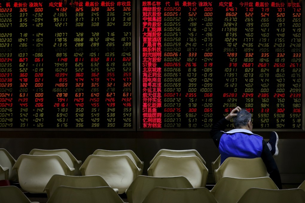 An investor monitors stock prices at a brokerage house in Beijing on December 14, a day when Asian markets tumbled after China reported weaker-than-expected economic data. Photo: AP