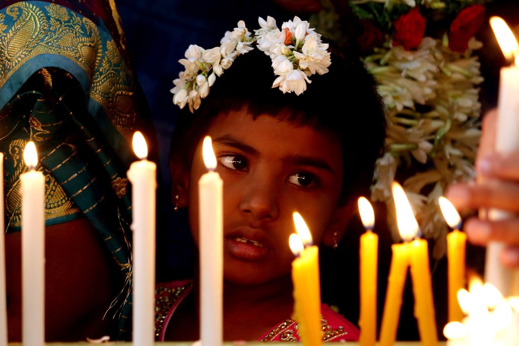 Indian Christians taking part in Christmas prayers at a church in Bangalore. Photo: EPA