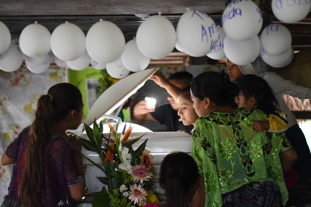 Relatives and neighbours of seven-year old Jakelin Caal, who died in a Texas hospital two days after being taken into custody by border patrol agents in a remote stretch of the New Mexico desert, attend her wake in her home village of Raxruha, 320km (199 miles) north of Guatemala City, on Monday. On Tuesday a second child died in US custody. Photo: AFP