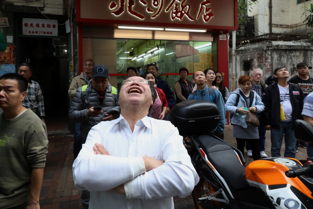The idea of banknotes raining down from the skies evokes smiles a day after the stunt, in Sham Shui Po on December 16. Photo: Sam Tsang