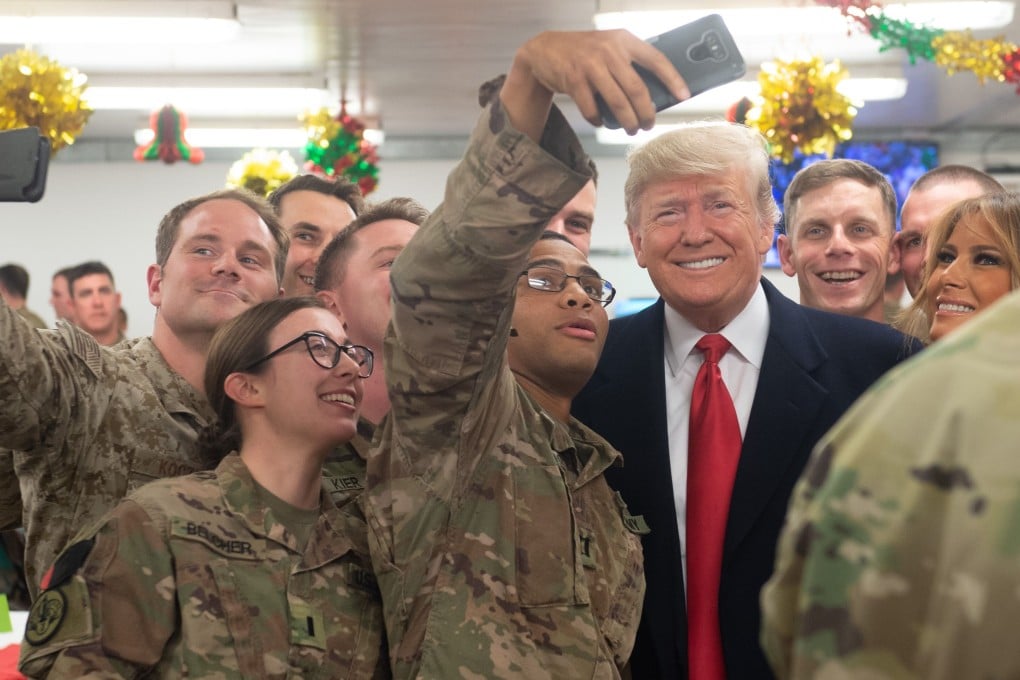 US President Donald Trump and first lady Melania Trump greet members of the US military during an unannounced trip to Al-Asad Air Base in Iraq. Photo: AFP