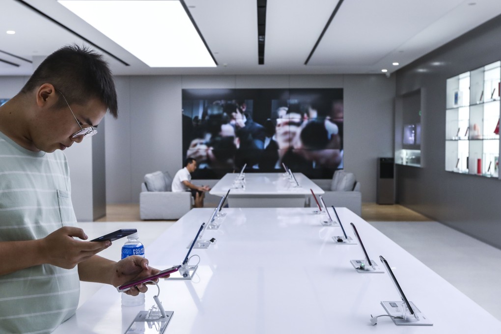A customer checks out the Oppo mobile phones on display at the Oppo store in the Consumer Electronics Exchange/Exhibition Centre (CEEC) in Futian district, Shenzhen. Photo: SCMP/Roy Issa