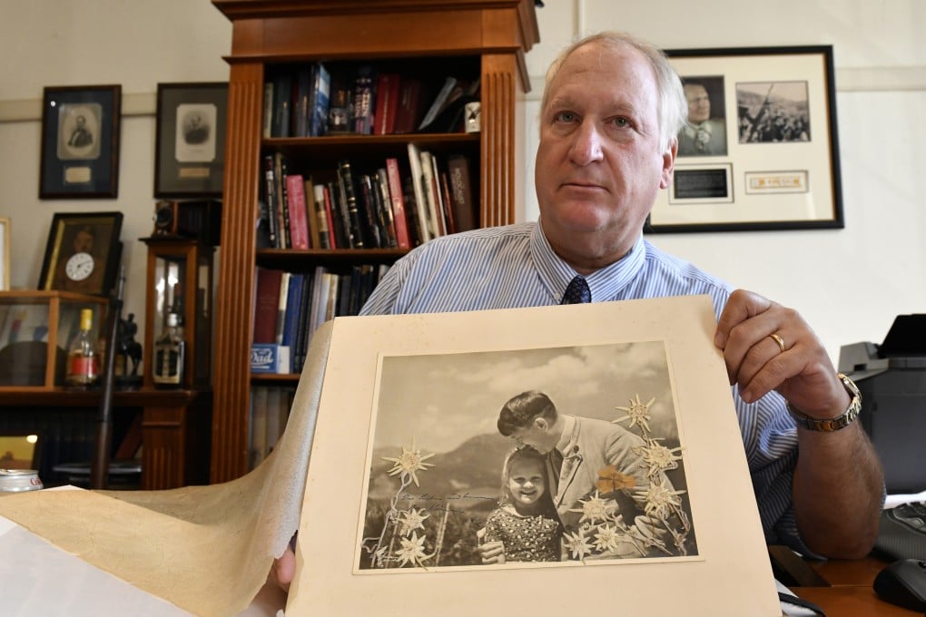 Basil “Bill” Panagopulos, president of Alexander Historical Auctions, with the 1933 Heinrich Hoffmann photograph of Hitler with Rosa Bernile Nienau known as “the Führer's child”, at Alexander Historical Auctions in Chesapeake City, Maryland. Photo: The Washington Post