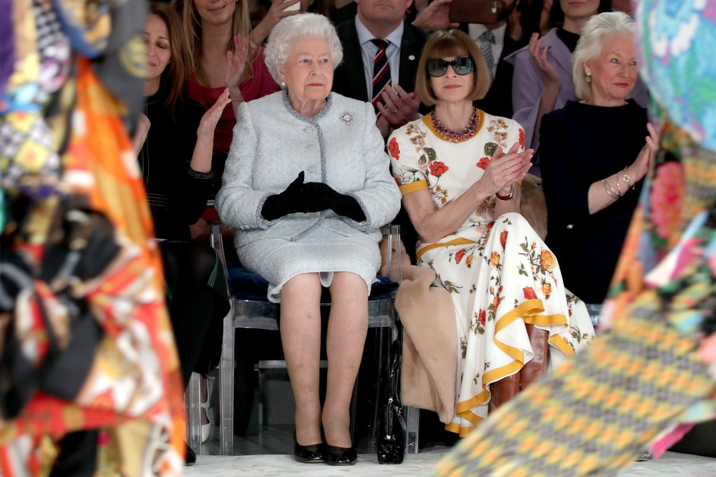Britain’s Queen Elizabeth II views Richard Quinn’s runway show before presenting him with the inaugural Queen Elizabeth II Award for British Design at London Fashion Week in February. Photo: Reuters