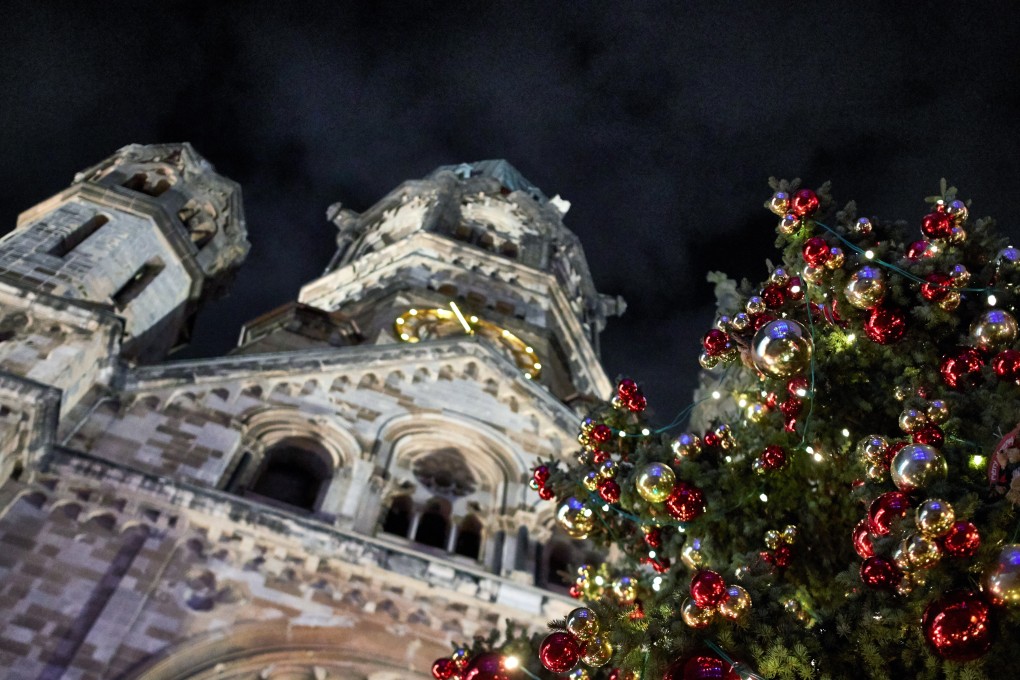 The Kaiser Wilhelm Memorial Church is seen behind a decorated Christmas tree, in Berlin. Photo: EPA