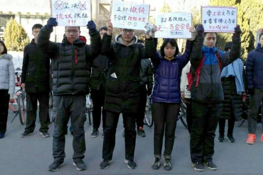 Students hold placards during the protest over a decision to install a new committee to run the Marxist Society. Photo: Handout