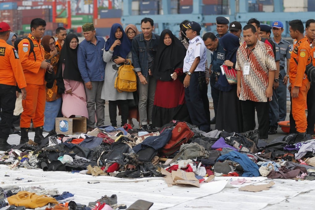 Relatives of victims of October’s Lion Air jet crash check personal belongings retrieved from the waters where the plane went down, at Tanjung Priok Port in Jakarta on October 31. Photo: AP