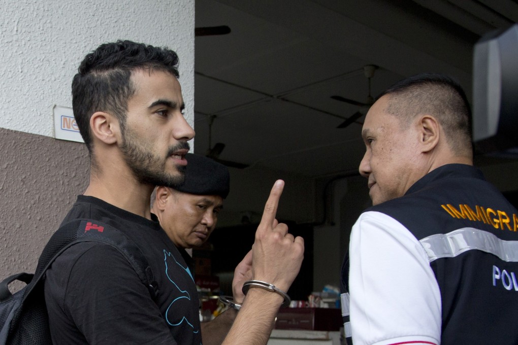 Hakeem al-Araibi with Thai immigration police. Photo: AP