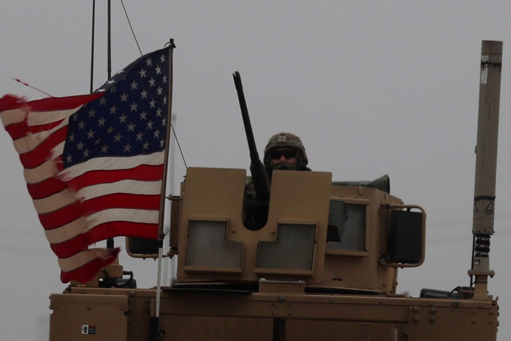 A US soldier rides in an armoured personnel carrier in Syria's northern city of Manbij. Photo: AFP