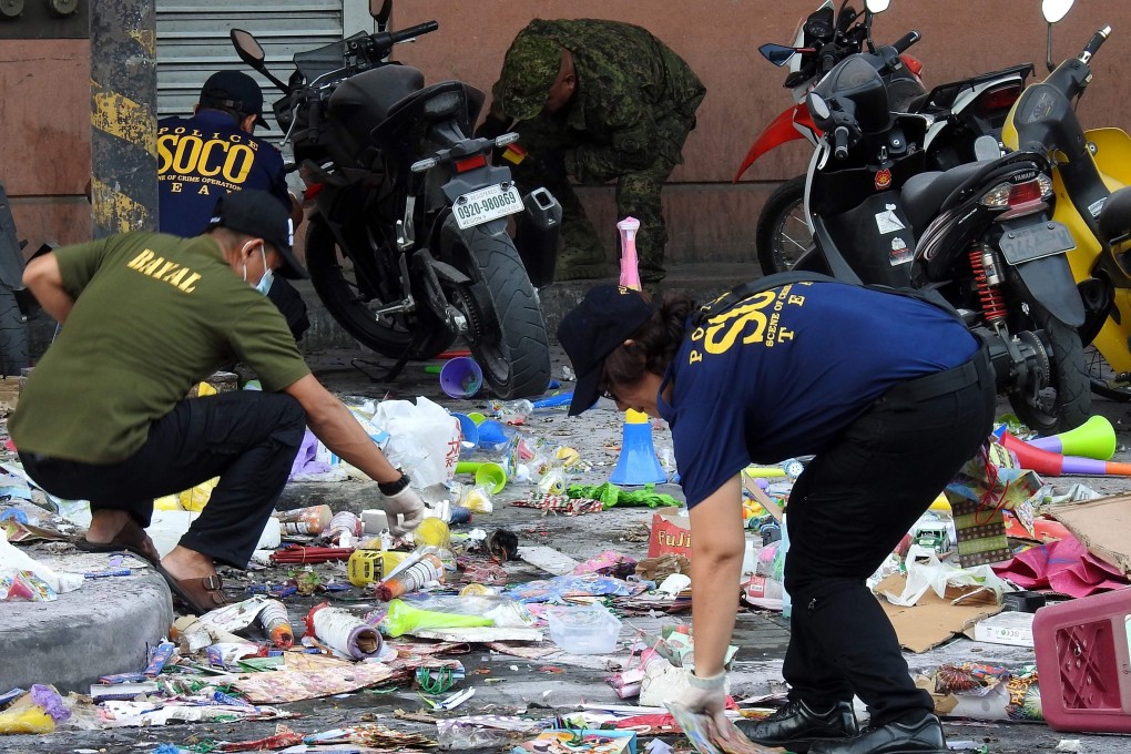 Police officers investigate the site of the explosion. Photo: AFP