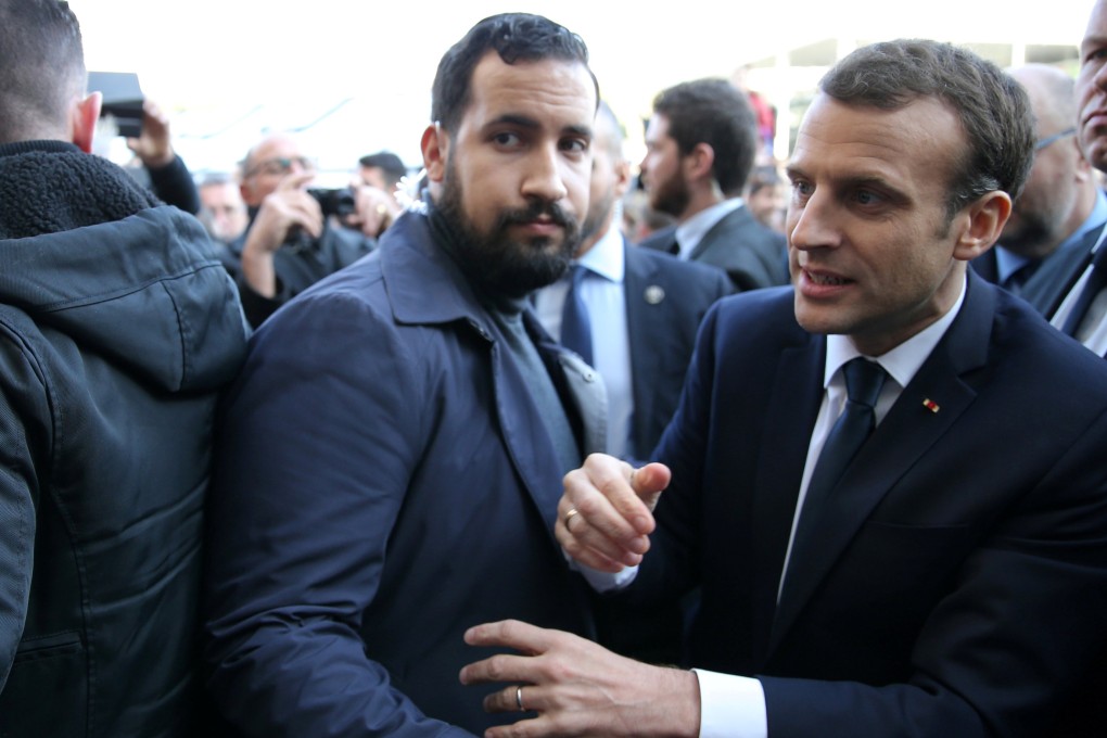 Former senior security officer Alexandre Benalla next to French President Emmanuel Macron during a visit to the Paris International Agricultural Show in February. Photo: Reuters