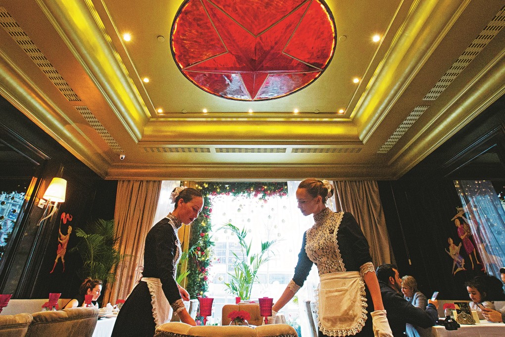 Waiters prepare tables for diners at the Grand Cafe Dr Zhivago in Moscow, Russia. Photo: Bloomberg