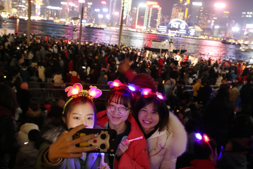 Friends wait to welcome 2019 with a selfie in Hong Kong, on the Tsim Sha Tsui waterfront. Photo: Winson Wong/SCMP
