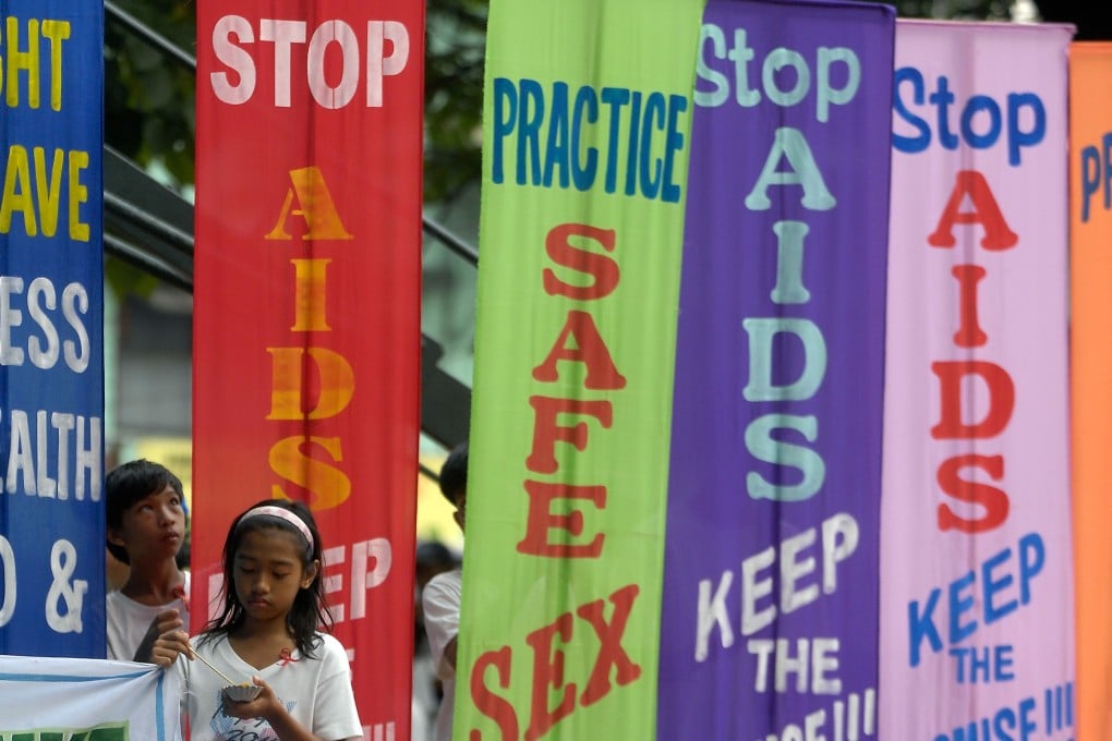 Children stand next to banners during a march to mark World Aids Day in Olongapo. The number of people dying from Aids is rising in the Philippines, whereas globally it is falling. Photo: AFP