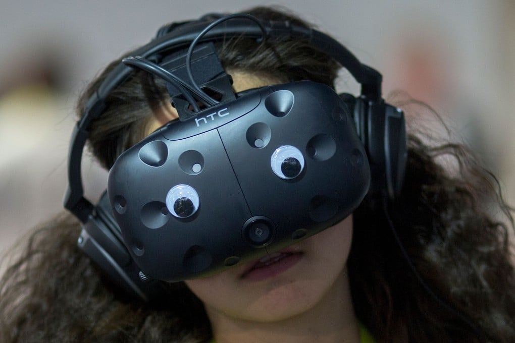 A woman wears a virtual reality simulator during the International Consumer Electronics Show in Las Vegas in 2017. To sustain the passion for inspiring and promoting the latest developments, we need to look to our schools, our universities and colleges to inspire the young. Photo: AFP