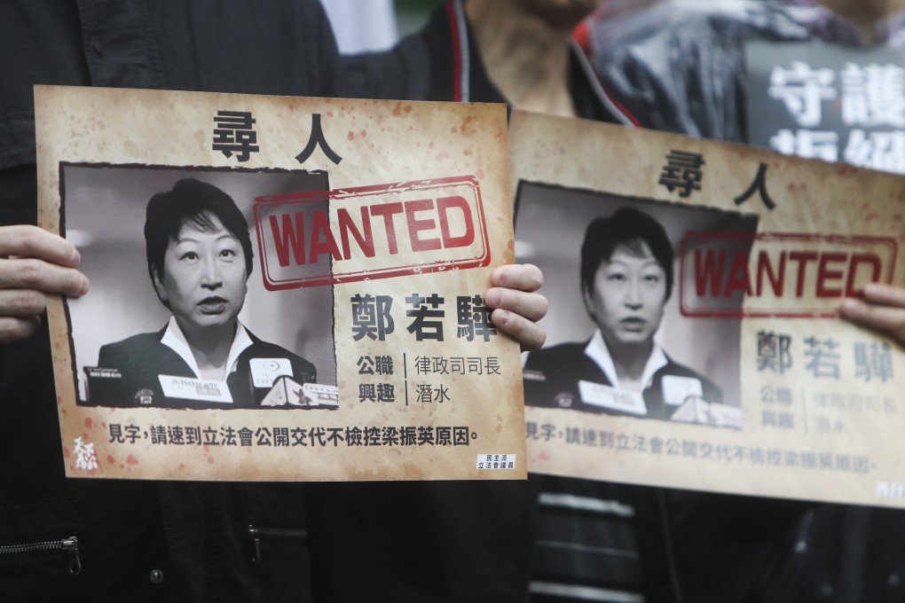 Protesters hold up placards picturing Secretary for Justice Teresa Cheng at a rally on December 23, calling on the minister to explain the justice department’s reasons for not prosecuting former chief executive Leung Chun-ying over the UGL payment. Photo: Winson Wong