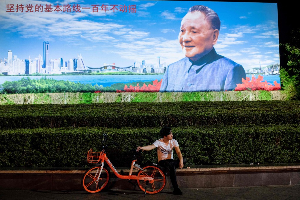 A Shenzhen resident rests in front of a poster of Deng Xiaoping in November. In December, China marked the 40th anniversary of reform and opening up, launched by Deng in December 1978, which has catapulted the country to the status of the world’s second-largest economy. Photo: AFP