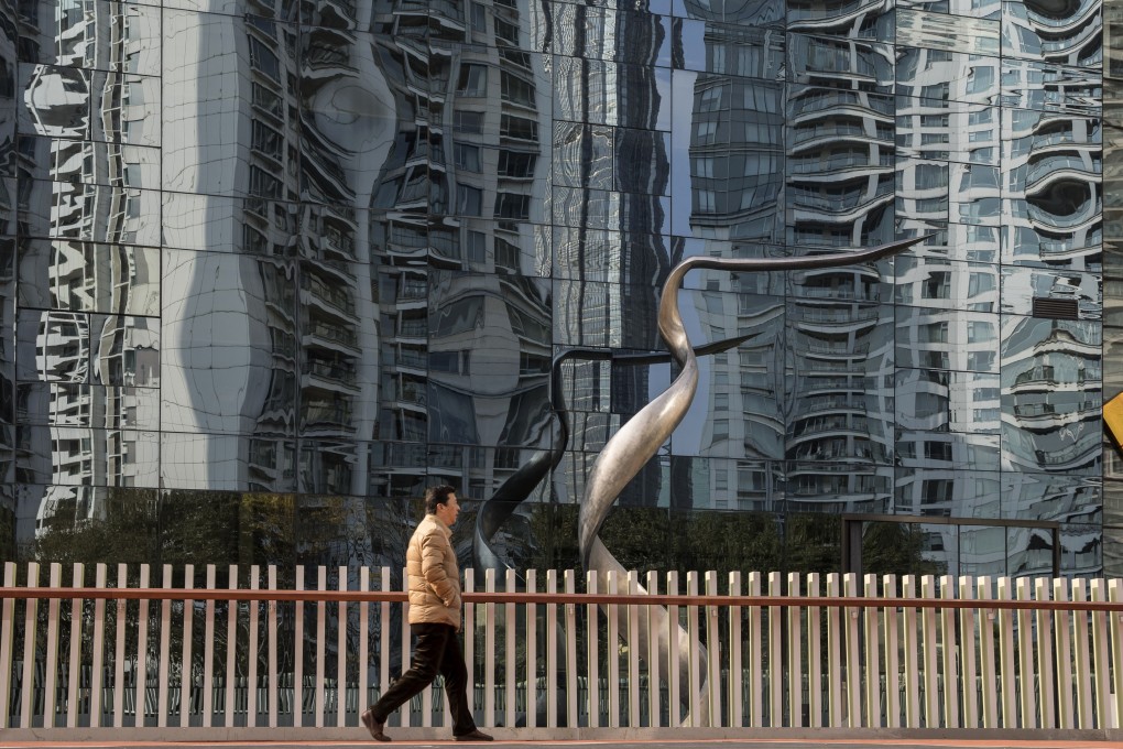 A pedestrian walks past a building in Shanghai. There are verbal reports of Chinese academics calculating China’s 2018 economic growth at as low as 1.5 per cent, rather than the official 6.5 per cent. Photo: Bloomberg