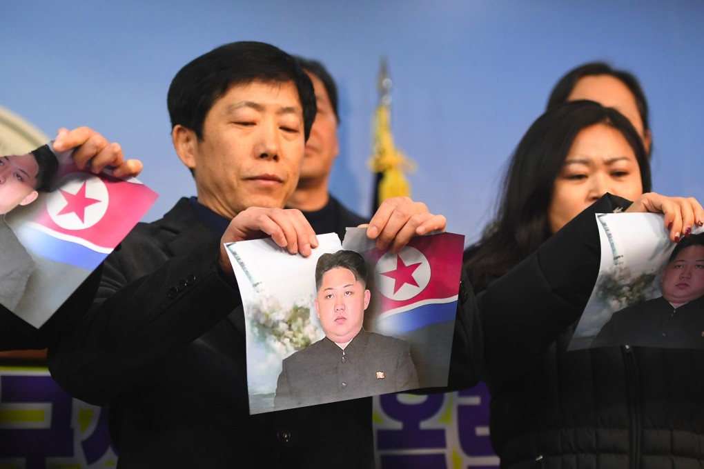 North Koreans who defected to the South tear pictures of North Korean leader Kim Jong-un. The latest high-profile defector is the North’s top diplomat in Italy, who has sought asylum in another country. Photo: AFP