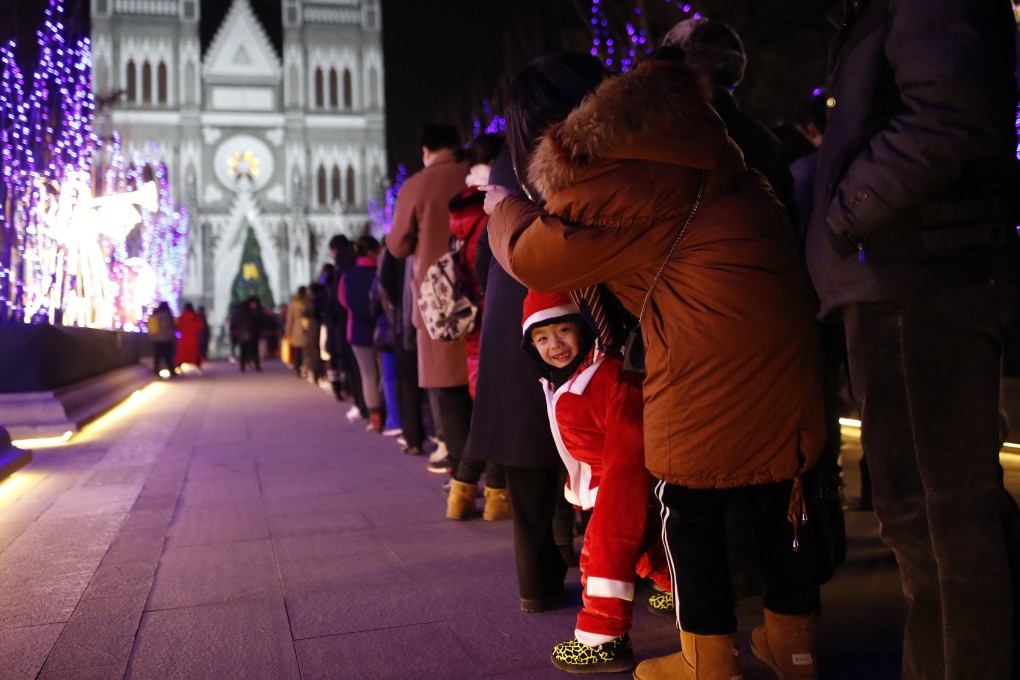 Catholics wait to attend Christmas Eve mass at the Xishiku Catholic Church in Beijing last month. Will 2019 be the year Pope Francis finally visits China? Photo: EPA-EFE