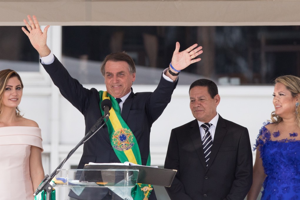Brazilian President Jair Bolsonaro – joined by first lady Michelle Bolsonaro (left), Vice-President Hamilton Mourao (second from right) and the vice-president’s wife Paula Mourao (right) – acknowledges crowds at his inauguration in Brasilia on Tuesday. Photo: Bloomberg