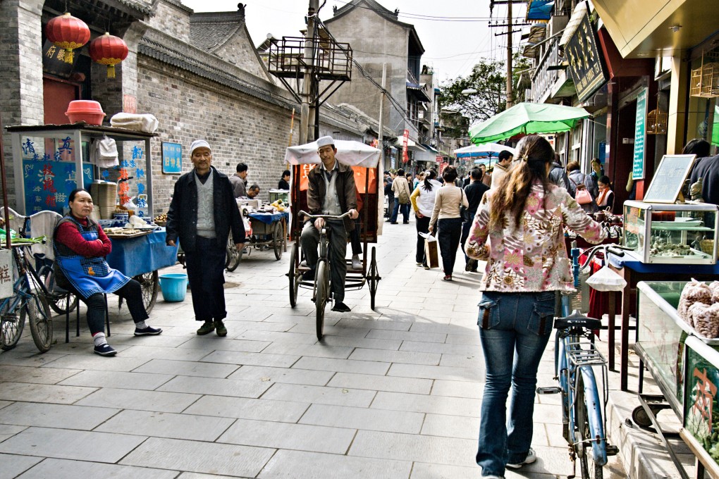 A street in the old Muslim quarter of Xi’an in Shaanxi province, with food vendors and pedicabs along with shoppers as of October 27, 2010. Photo: 4PAX China