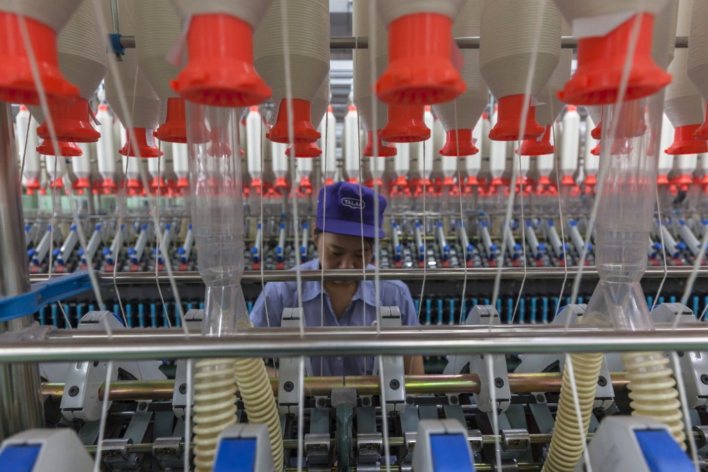A woman works in a textile factory in this file photo: Photo: EPA