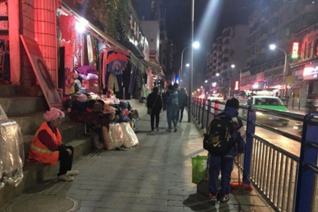 Long Guotao, 11, cleans the street so his cleaner mother (seated left) can go home early, in China’s southern Guizhou province. Photos of the schoolboy’s efforts melted hearts when a passer-by posted them on Weibo, China’s Twitter. Photo: Weibo
