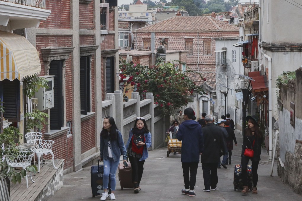 Tourists walk around Gulangyu, a popular pedestrian-only island off the coast of Xiamen. Photo: Roy Issa