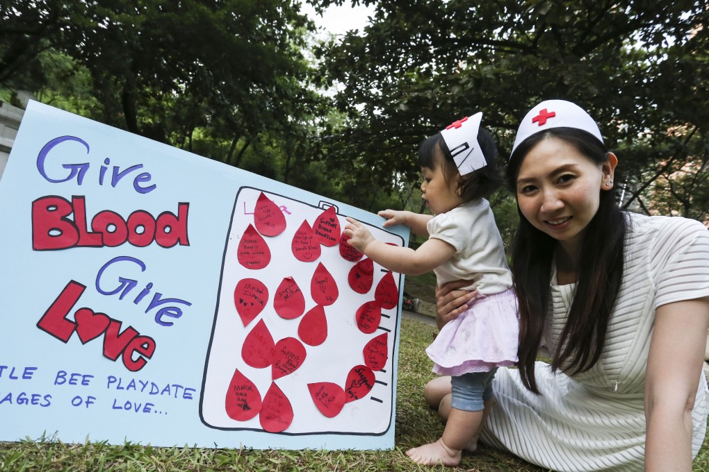 Hong Kong mother Yelly Chui Nga-lee and her 11-month-old daughter promote blood donation. Photo: Jonathan Wong