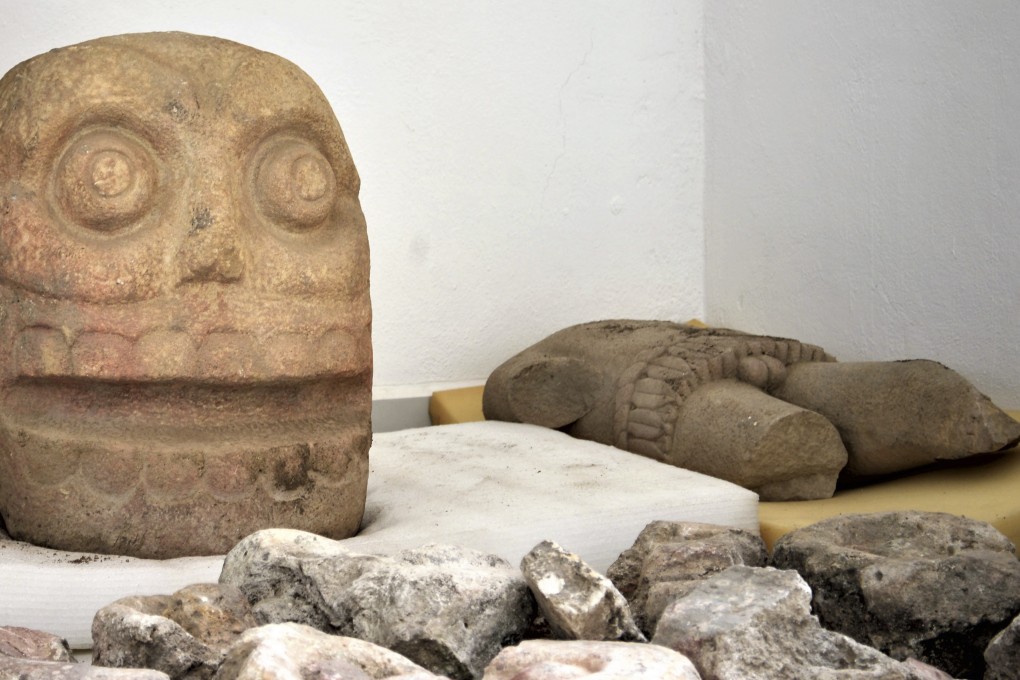 A skull-like stone carving and a stone torso depict Xipe Totec, the “Flayed Lord”, a pre-Hispanic fertility god depicted as a skinned human corpse. They were excavated from the Ndachjian – Tehuacan archaeological site in Tehuacan, Puebla state, at a temple dedicated to the deity. Photo: AP