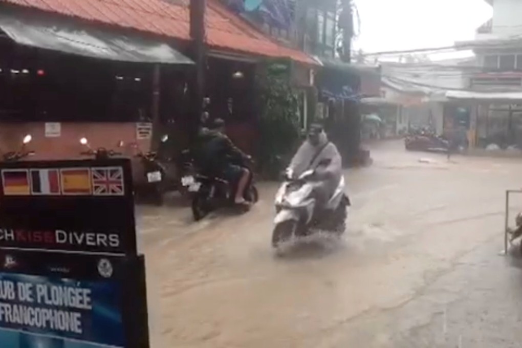 Motorcyclists ride along a flooded street on Koh Tao, Thailand on January 5, 2019. Photo: Amanda Figlarska/Reuters