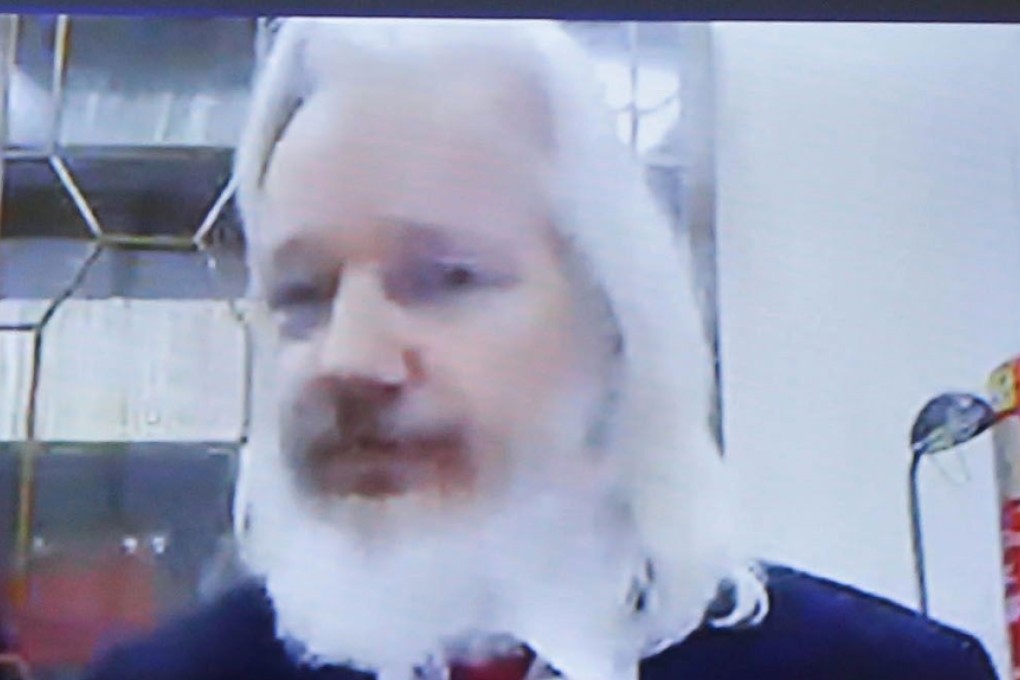 Julian Assange sports long hair and a beard in a December videoconference. Photo: AFP