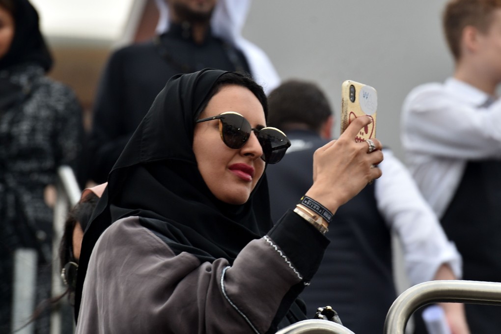 A Saudi woman looking at her mobile phone. Photo: AFP