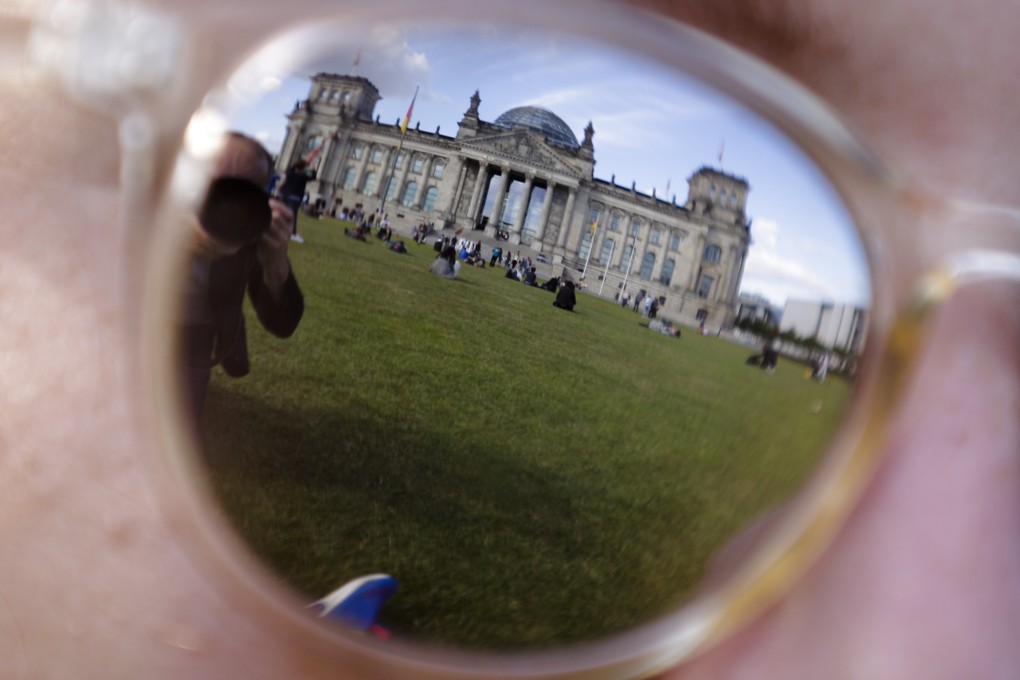 File photo of the Reichstag, which host the German parliament, in Berlin, reflected in sunglasses. Photo: AP