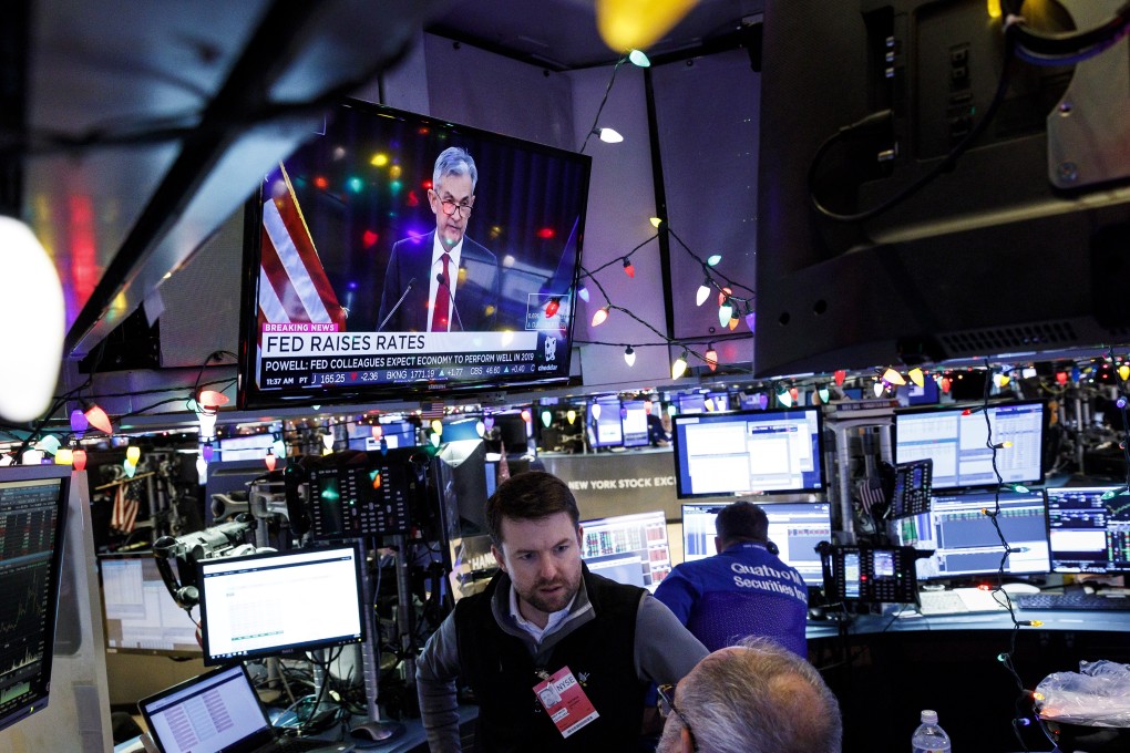 Traders work as Federal Reserve Chairman Jerome Powell gives a press conference following the announcement of a rate increase in December 2018. Photo: EPA